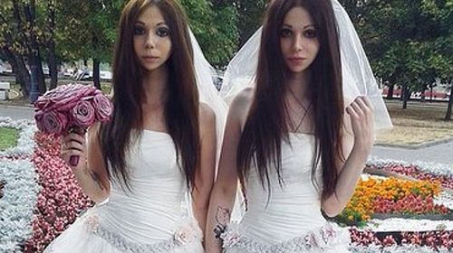 Heterosexual couple tie the knot dressed as brides