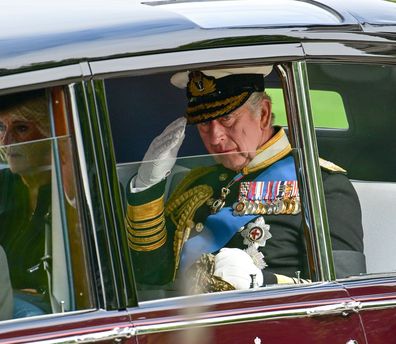King Charles III and Camilla, Queen Consort are seen in a car as the coffin of Queen Elizabeth II is transferred from the gun carriage to the hearse at Wellington Arch following the State Funeral of Queen Elizabeth II at Westminster Abbey on September 19, 2022 in London, England. 