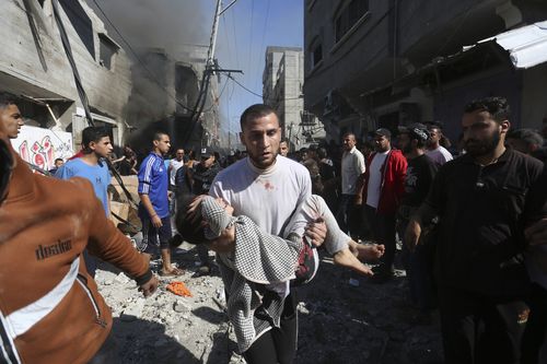 Palestinians rescue survivors after an Israeli strike on Rafah, Gaza Strip, Friday, Nov. 17, 2023. 