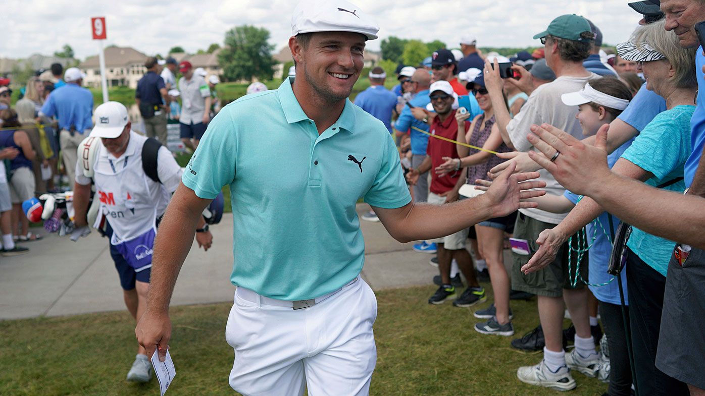 Bryson DeChambeau greets fans as he leaves the ninth hole during the second round of the 3M Open golf tournament