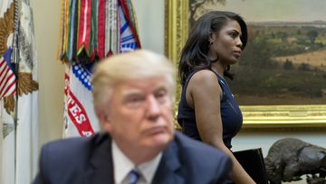 White House Director of communications for the Office of Public Liaison Omarosa Manigault, right, walks past President Donald Trump during a meeting on healthcare in the Roosevelt Room of the White House in Washington, Monday, March 13, 2017. (AP Photo/Pablo Martinez Monsivais)