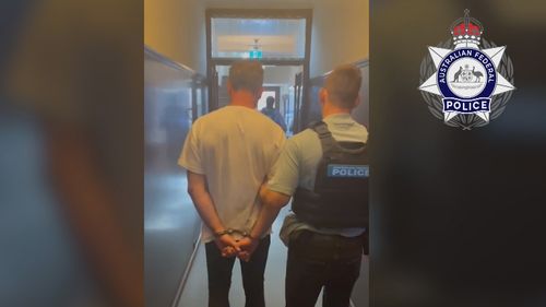 A man being arrested in handcuffs for impersonating a police officer
