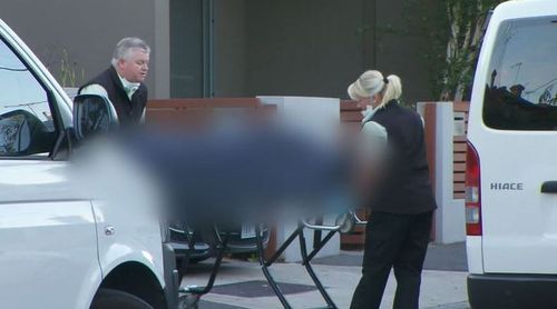 Ms Gatt's body is removed from the home. (9NEWS)