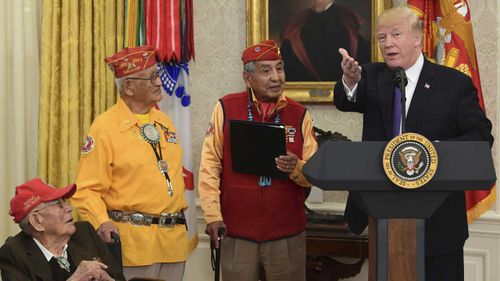 President Donald Trump with a few of the last remaining Navajo code-talkers. (AAP)