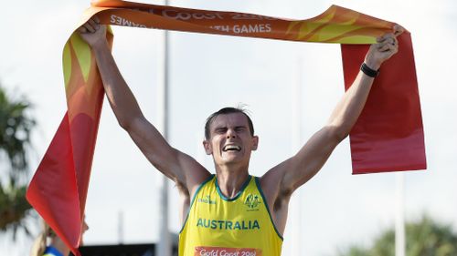 Dane Bird-Smith of Australia crosses the finish line to win the Men's 20km Race Walk final on day four. (AAP)