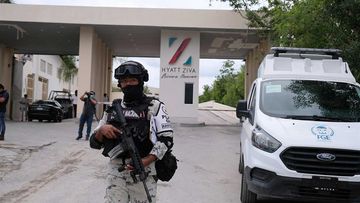 Government forces guard the entrance of hotel after an armed confrontation near Puerto Morelos, Mexico.
