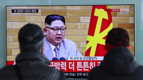 South Koreans watch a TV news program showing North Korean leader Kim Jong Un's New Year's speech on January 1, 2018. (AAP)