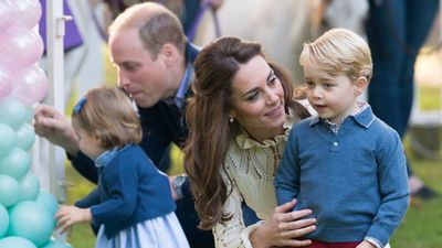 <p>Kate shares a sweet moment with George at a children's party for military families, 2016</p>