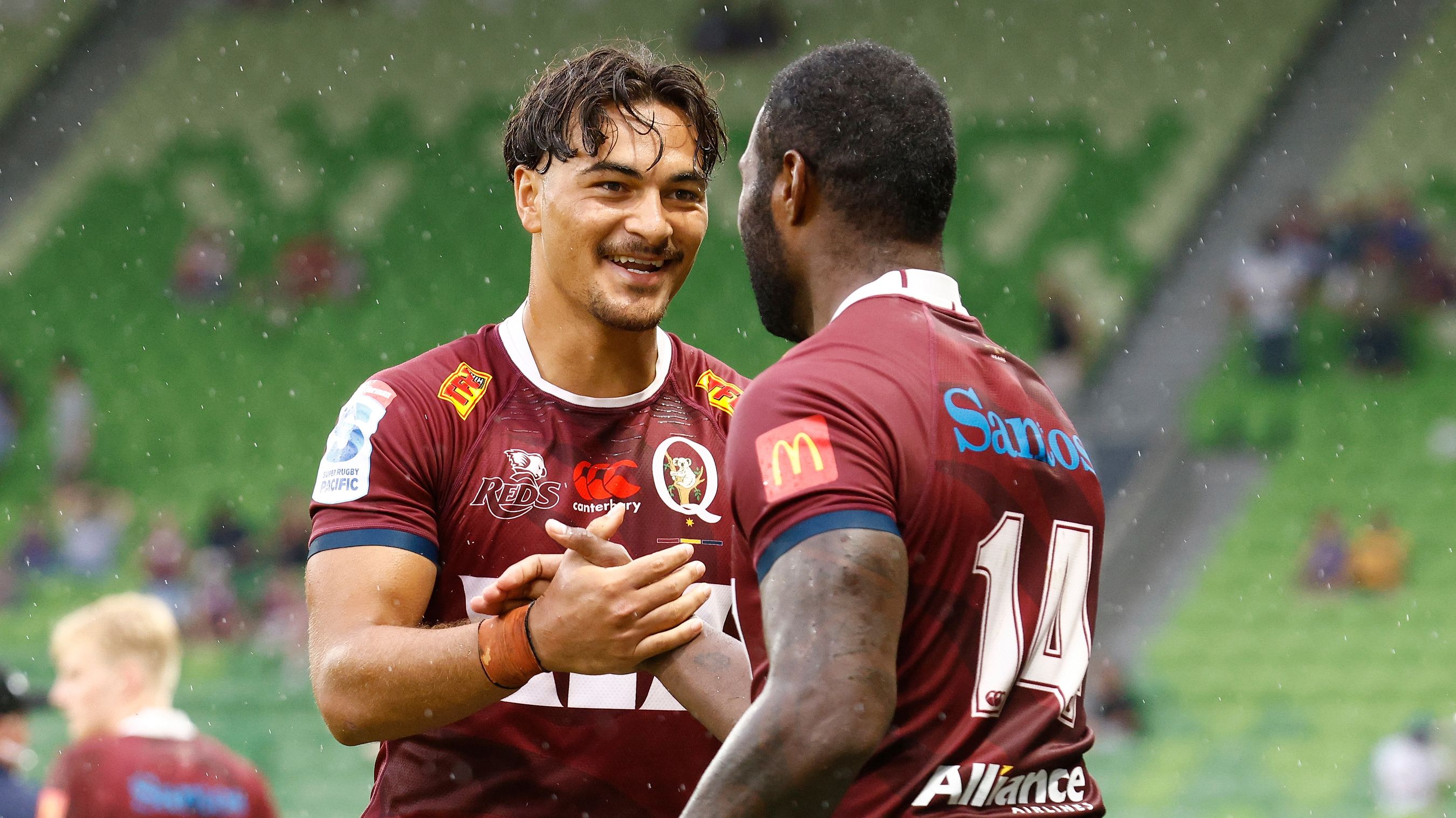 Jordan Petaia and Suliasi Vunivalu of the Reds celebrate victory during the round two Super Rugby Pacific over the Force.