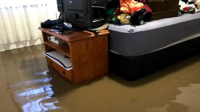 The Snells rushed through their home lifting what they could from the path of the floodwater.