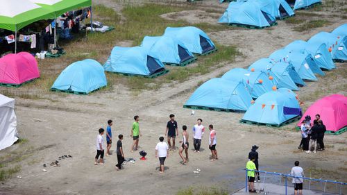 Participants play with a ball at the camping site for the 25th World Scout Jamboree in South Korea on August 4.