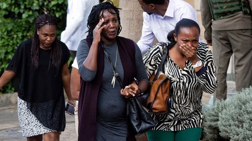 People in shock as they flee a Nairobi hotel under attack.