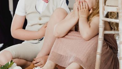 Children sitting on the floor at wedding venue