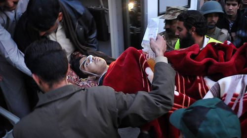 Pakistani men transport a wounded student to hospital after Taliban gunmen attacked a school in Peshawar. (Getty)
