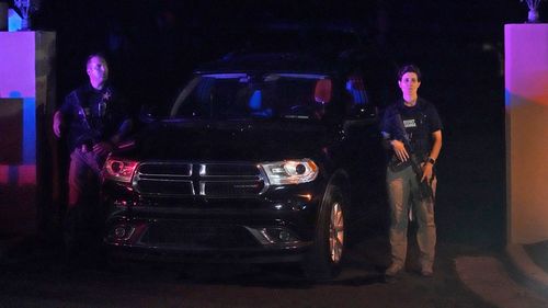 Armed Secret Service agents stand outside an entrance to former President Donald Trump's Mar-a-Lago estate