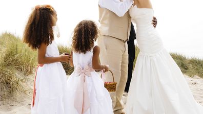 Bride and groom two children beach wedding