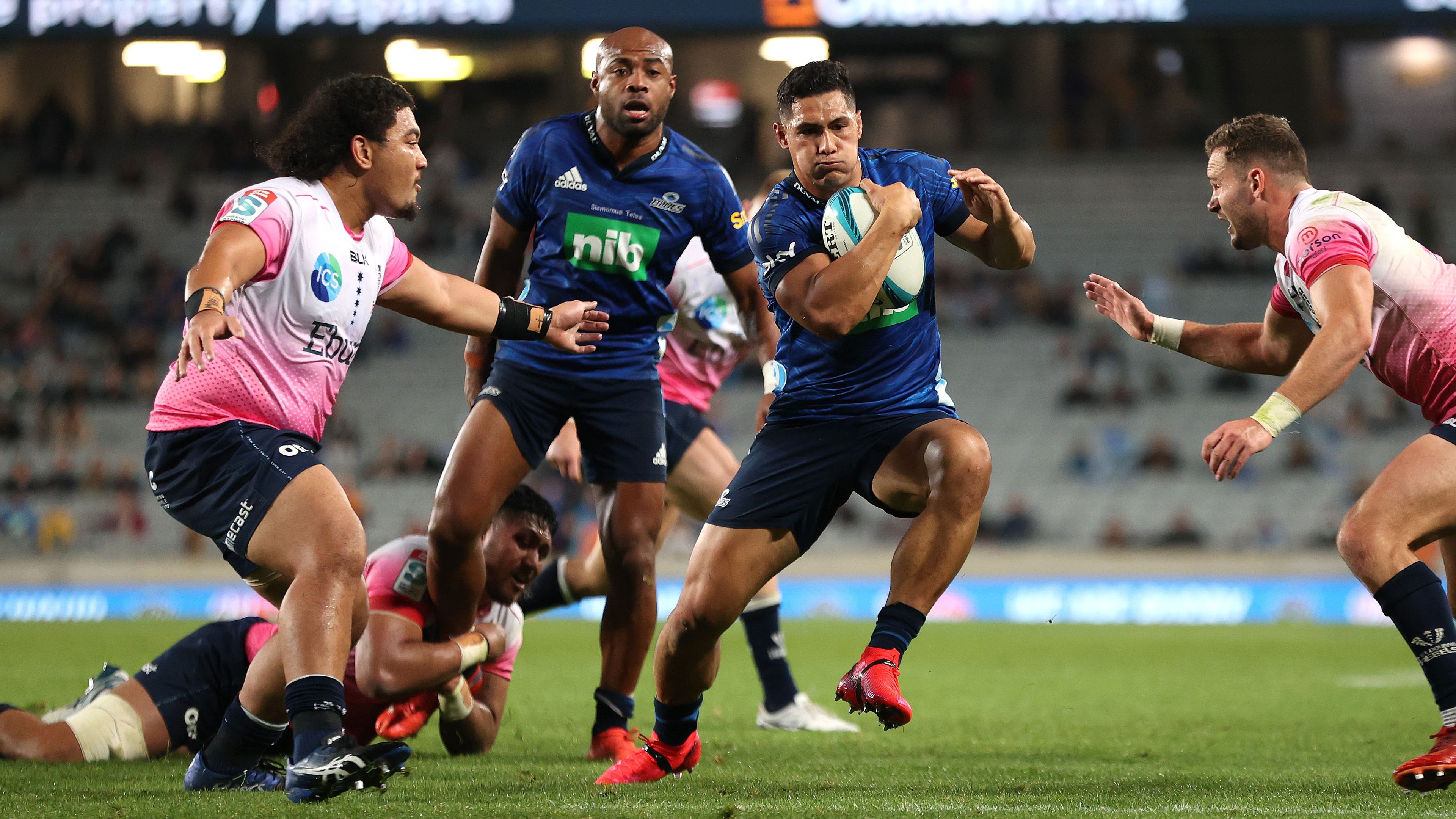 Roger Tuivasa-Sheck- of the Blues is tackled during the Round 12 Super Rugby Pacific match between the Blues and the Melbourne Rebels.