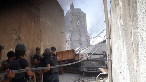 The Iraqi Army handles a massive cable outside the ruins of the destroyed leaning minaret of al-Nuri mosque. (Owen Holdaway)