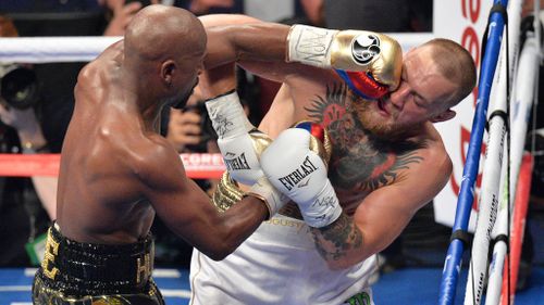 Floyd Mayweather Jnr and Conor McGregor during their fight at the T-Mobile Arena in Las Vegas. (Image: PA)