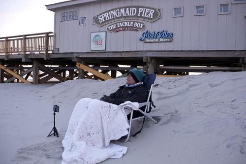 Peter Flynn of Myrtle Beach sits on the beach near the Springmaid Pier, Saturday, Feb. 4, 2023, in Myrtle Beach, S.C. He witnessed the Chinese balloon getting shot down in this area earlier in the day. 