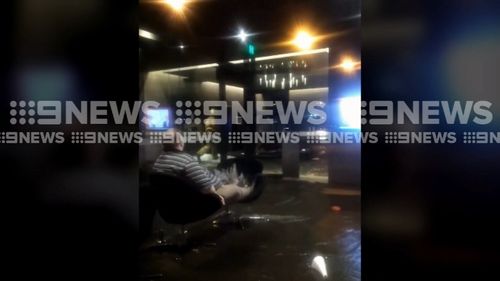 120 people were evacuated from the premises as thousands of litres of water flowed through the building and out of the front door. Picture: 9NEWS.