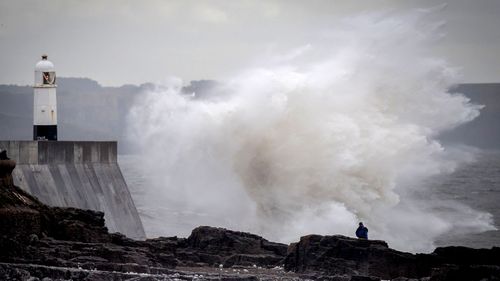 Waves hit the seafront in Porthcawl, Wales as storms lash the UK.