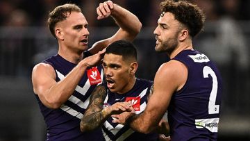 Fremantle&#x27;s Will Brodie, Michael Walters and Griffin Logue celebrate a goal