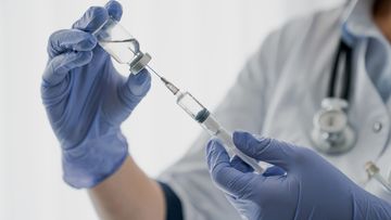 Nurse holding a needle. Injection. Vaccine.