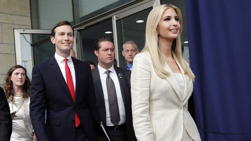 White House senior advisors Jared Kushner (C) and Ivanka Trump (R) arrive for the opening ceremony at the US consulate
