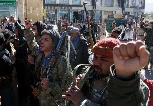 Yemeni protestors loyal to the Houthi movement lift their rifles as they participate in a protest held against Israel's ongoing war on Gaza.