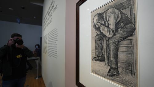 A photographer takes pictures of Study for "Worn Out", a drawing by Dutch master Vincent van Gogh, dated Nov. 1882, on public display for the first time at the Van Gogh Museum in Amsterdam.