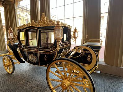 The Diamond Jubilee State Coach appears as you enter Buckingham Palace for the annual Summer Opening, which this year features a coronation exhibition.