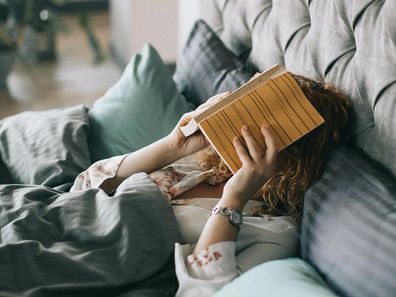 Stock image of a woman in bed.