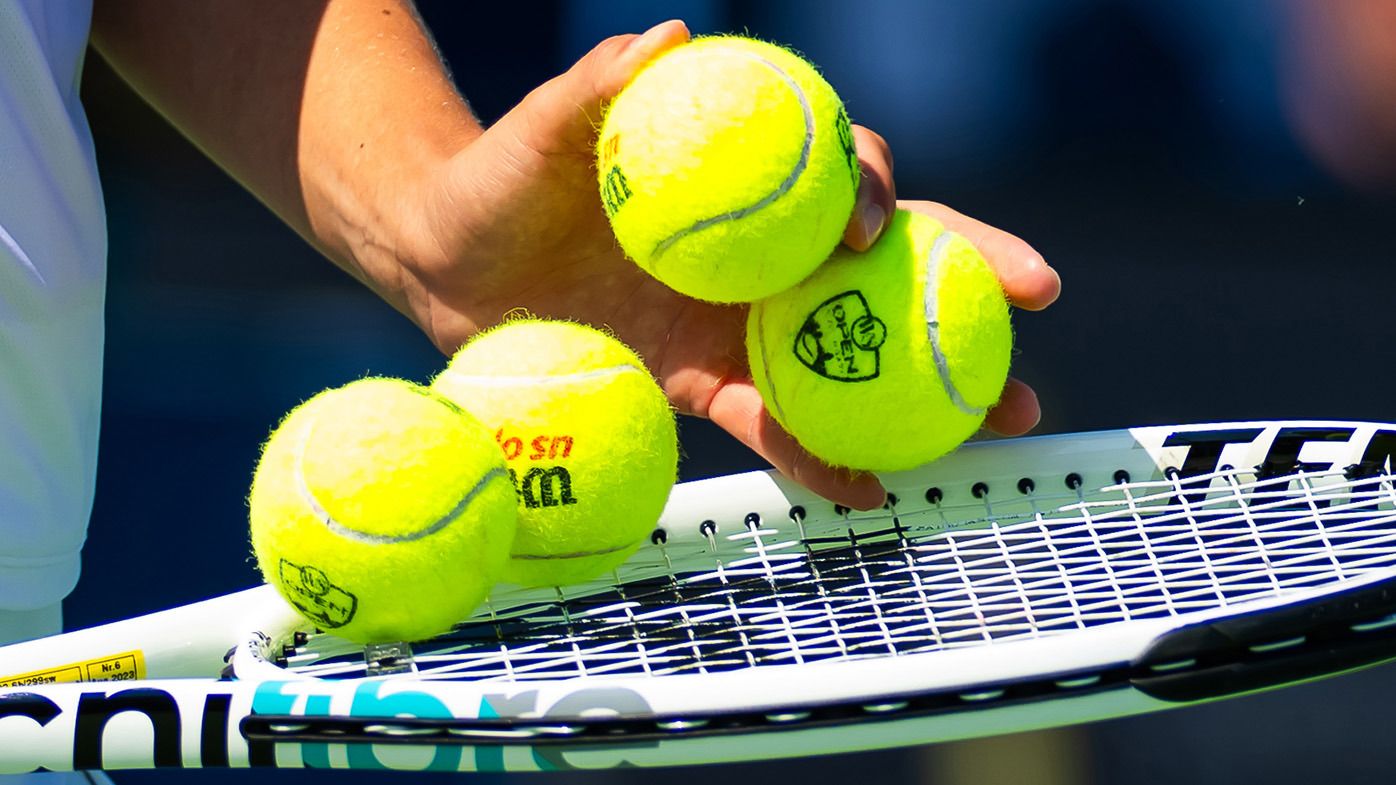 Tennis balls on a racquet. 