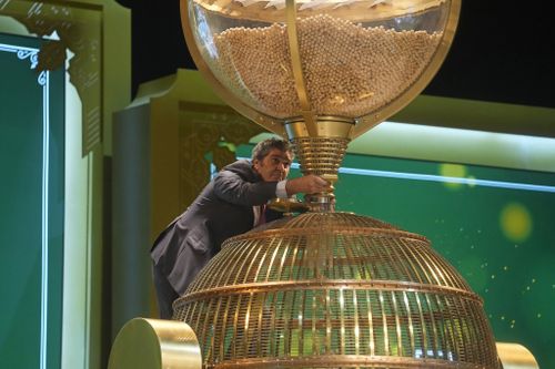 A worker supervises the moment when lottery balls are filled into a drum before the draw at Madrid's Teatro Real opera house during Spain's bumper Christmas lottery draw known as El Gordo, or The Fat One, in Madrid, Spain, Friday, Dec. 22, 2023 