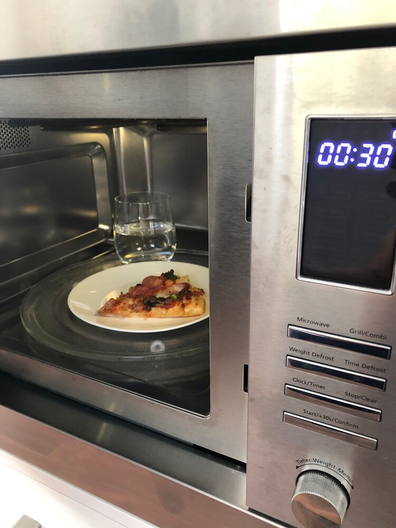 Leftover pizza slice hack with cup of water