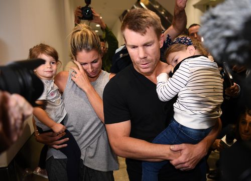 David and Candice Warner and their children fight through the media scrum at Sydney Airport after the ball tampering scandal. Picture: AAP