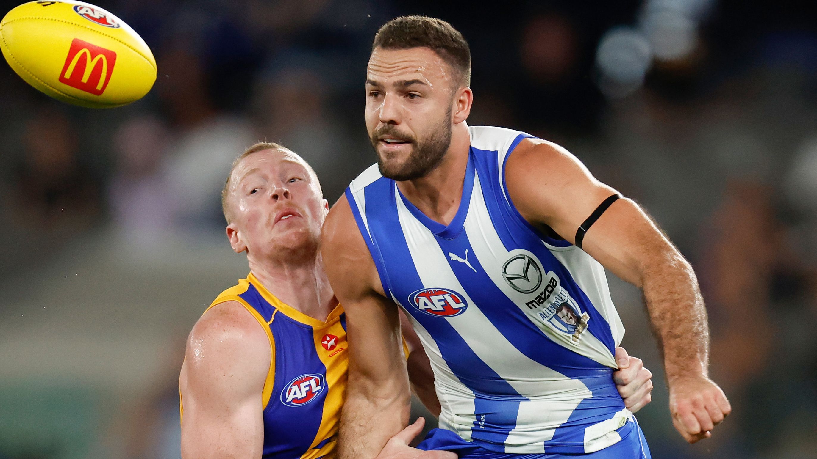 MELBOURNE, AUSTRALIA - MARCH 18: Griffin Logue of the Kangaroos is tackled by Bailey J. Williams of the Eagles during the 2023 AFL Round 01 match between the North Melbourne Kangaroos and the West Coast Eagles at Marvel Stadium on March 18, 2023 in Melbourne, Australia. (Photo by Michael Willson/AFL Photos)