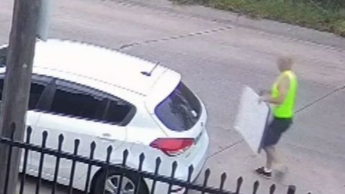 9News was shown footage of a man removing Liberal Party advertisements from a fence in Revesby and putting them in his car.