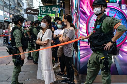 Riot police detain a group of people during a anti-government protest. Nearly 300 people were arrested during the protest against the government's decision to postpone the legislative council election due to the Covid-19 and the newly imposed national security law. 
