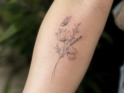 Delicate flower tattoo by Claire Benson.