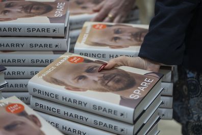 Members of staff place the copies of the new book by Prince Harry called "Spare" at a book store in London, Tuesday, Jan. 10, 2023. 