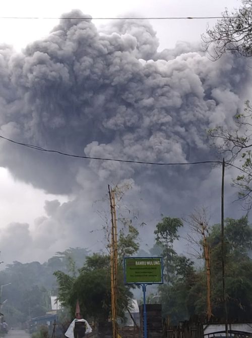 In this photo released by Indonesia's National Disaster Mitigation Agency (BNPB) Mount Semeru spews volcanic material during an eruption in Lumajang, East Java, Indonesia, Saturday, Jan. 16, 2021.