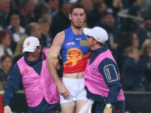 Brisbane Lions defender Darcy Gardiner is helped from the field after suffering concussion from a 'falcon'. (Getty)
