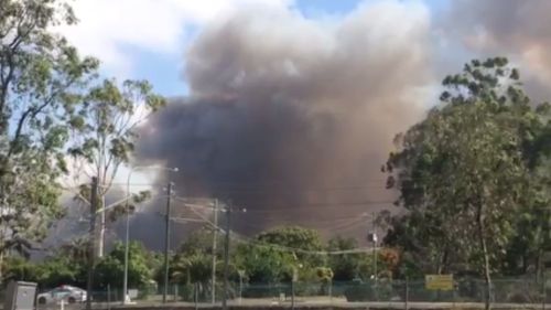 A primary school north of Brisbane has been evacuated as two grass fires burn nearby. (Twitter via Jarred Maunder)