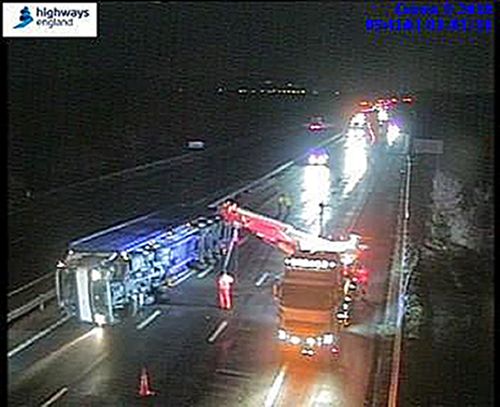 CCTV still issued by Highways England of an overturned truck between J9-J8 on the M5 as Storm Eleanor lashed the UK. (AAP)