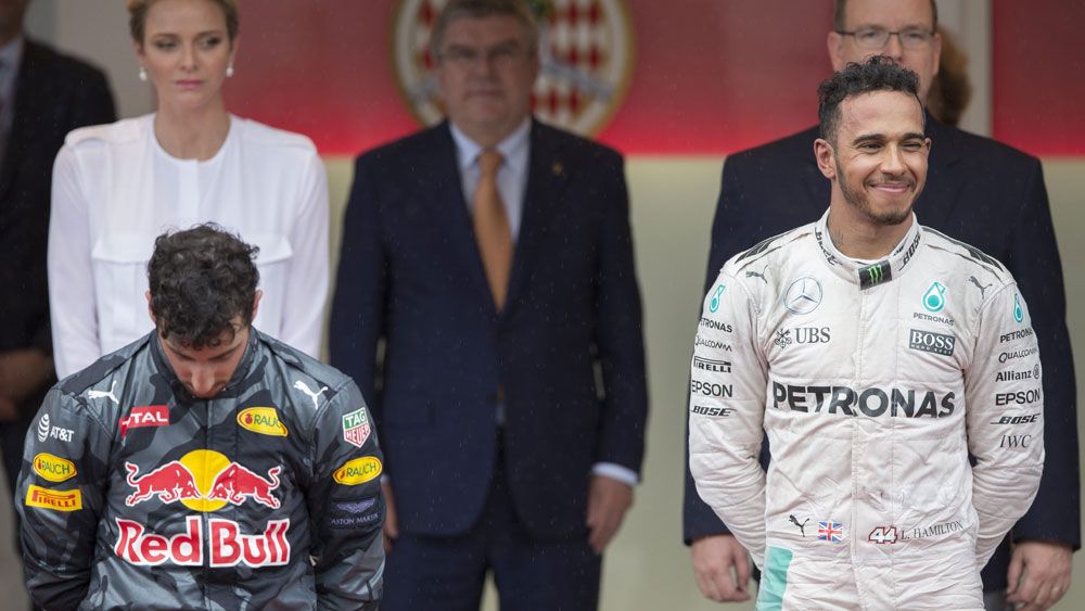 Lewis Hamilton celebrates his Monaco GP win while Daniel Ricciardo (left) ponders what might have been. (AAP)