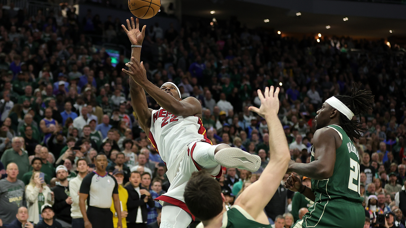 Jimmy Butler of the Miami Heat shoots over Pat Connaughton of the Milwaukee Bucks as regulation time expires in game 5 of the Eastern Conference First Round Playoffs.