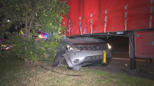 Alleged disqualified driver crashes into semi-trailer in Wetherill Park, Sydney.