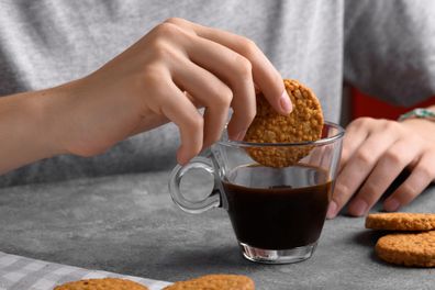 Dipping biscuit into drink